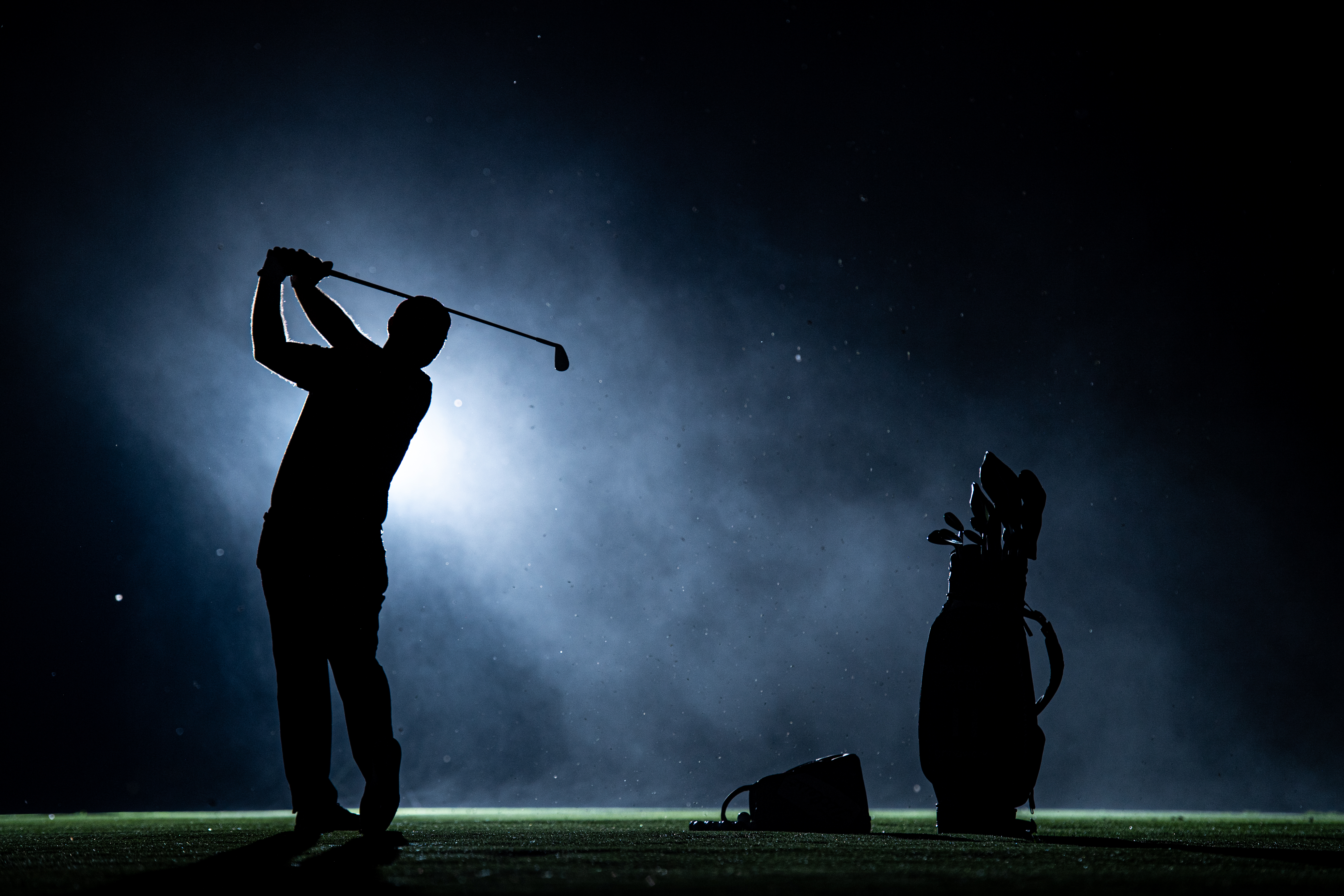 Patrick Reed silhouette swing in the dark