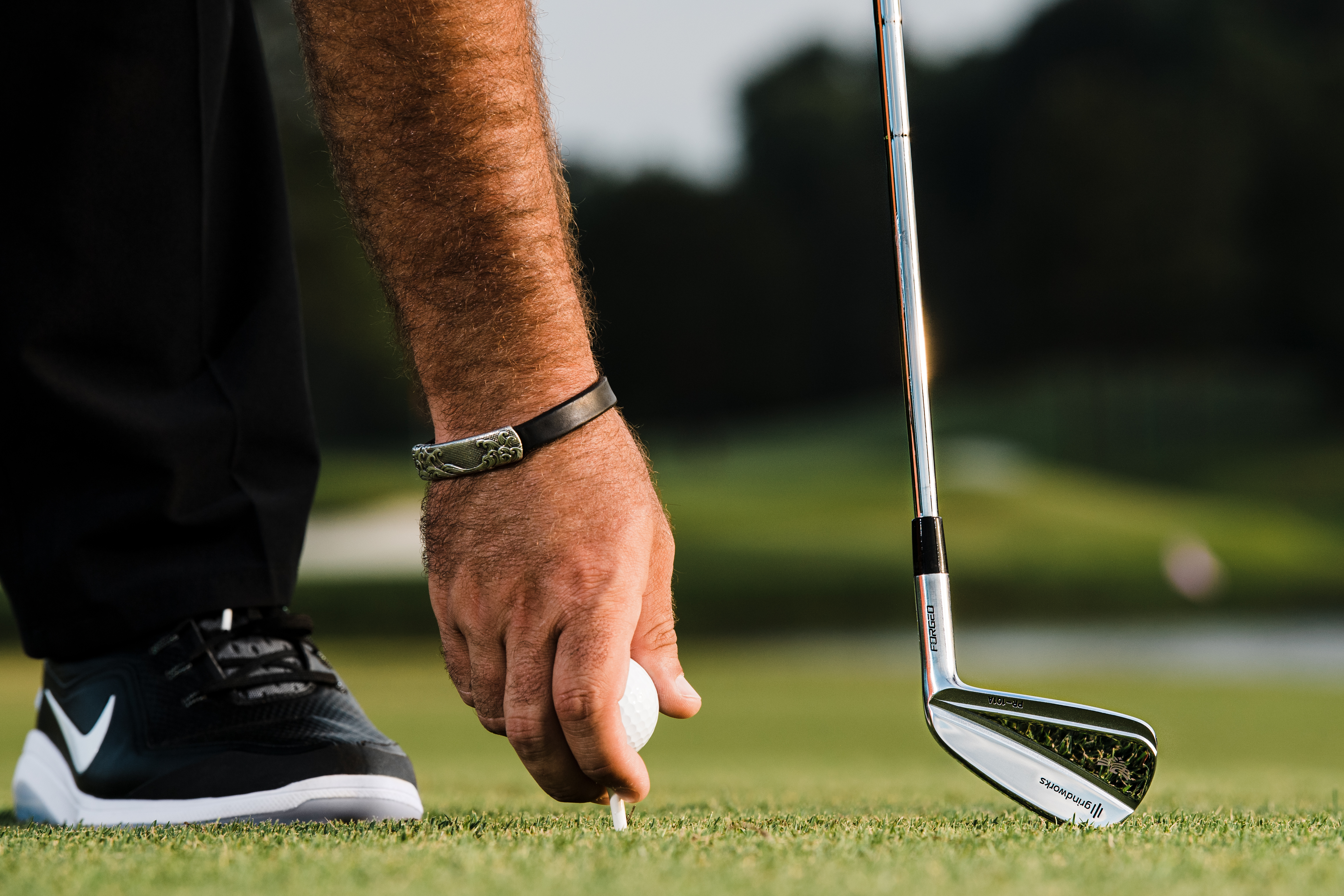 Patrick Reed close-up placing ball on tee