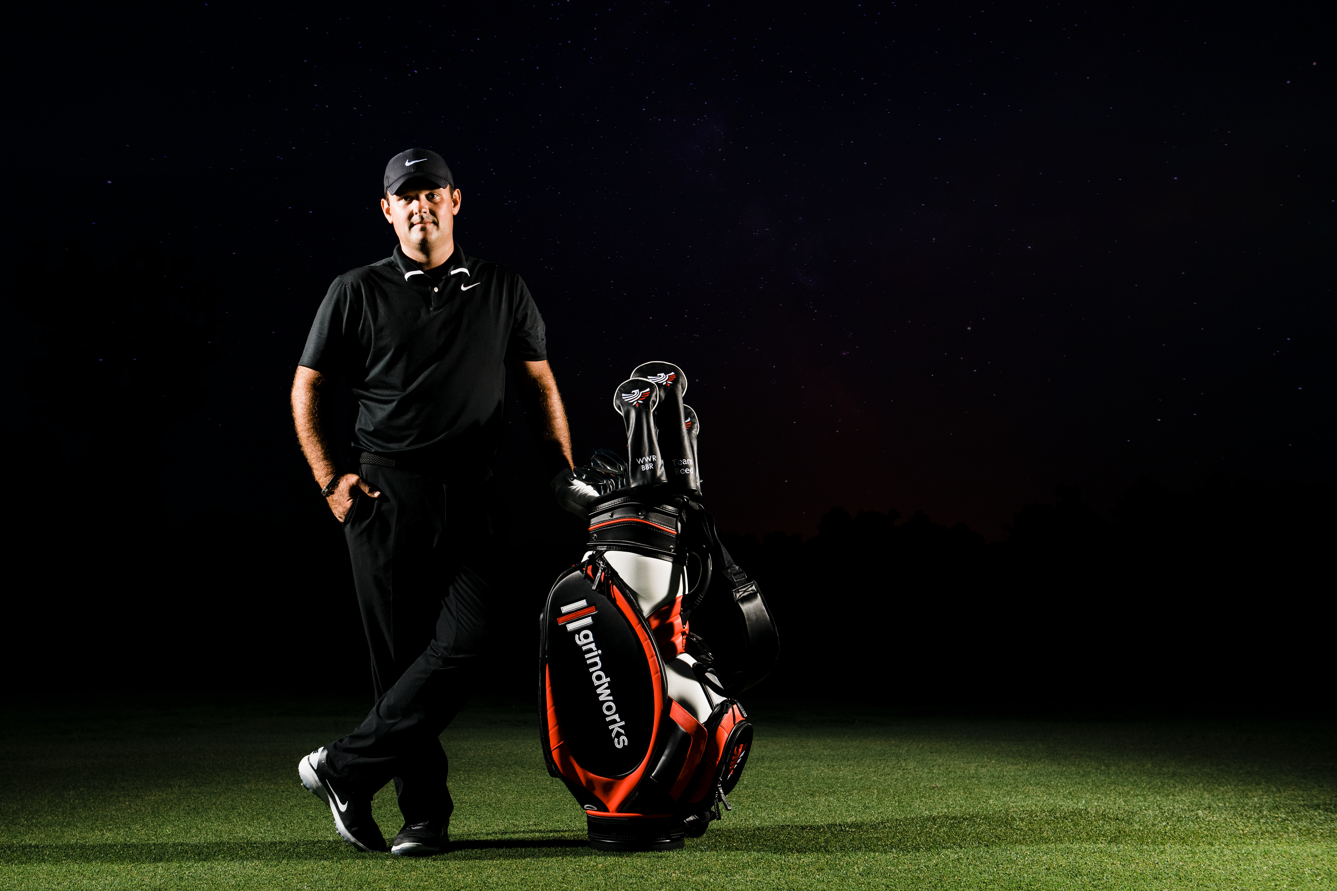 Patrick Reed standing next to his golf bag